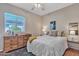 Bedroom featuring ceiling fan, hardwood floors, and comfortable bed at 877 E La Costa Pl, Chandler, AZ 85249