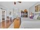 This bedroom features a ceiling fan, hardwood floors, and a bookshelf at 877 E La Costa Pl, Chandler, AZ 85249