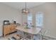 Bright dining area with modern light fixture and shuttered windows at 877 E La Costa Pl, Chandler, AZ 85249