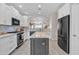 Modern kitchen with stainless steel appliances, island, and white cabinetry at 877 E La Costa Pl, Chandler, AZ 85249