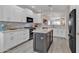 Modern kitchen with stainless steel appliances, island, and white cabinetry at 877 E La Costa Pl, Chandler, AZ 85249