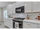 Modern kitchen with stainless steel appliances and white cabinetry at 877 E La Costa Pl, Chandler, AZ 85249