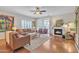 Cozy living room featuring a fireplace, plush seating, and hardwood floors at 877 E La Costa Pl, Chandler, AZ 85249