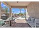 Relaxing covered patio overlooking the swimming pool with patio furniture and lush landscaping at 877 E La Costa Pl, Chandler, AZ 85249