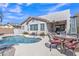 Inviting pool surrounded by outdoor seating and lush landscaping for relaxation at 877 E La Costa Pl, Chandler, AZ 85249