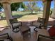 Relaxing covered patio with comfortable seating and views of the lush green golf course at 9734 W Kerry Ln, Peoria, AZ 85382