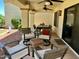 Inviting covered patio with ceiling fans, comfortable seating, and an outdoor dining area at 9734 W Kerry Ln, Peoria, AZ 85382
