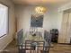 Inviting dining area with glass-top table, decorative lighting, and serene window views at 9734 W Kerry Ln, Peoria, AZ 85382