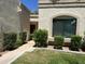 Inviting home exterior with desert landscaping, manicured bushes, and a charming walkway to the front door at 9734 W Kerry Ln, Peoria, AZ 85382