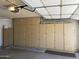 Spacious garage features lots of custom cabinets for storage and organization at 9734 W Kerry Ln, Peoria, AZ 85382