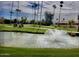 Golf course with lush grass, mature trees, and a decorative fountain in the foreground at 9734 W Kerry Ln, Peoria, AZ 85382