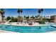 Community pool with several swimmers enjoying the sun on a beautiful summer day at 9734 W Kerry Ln, Peoria, AZ 85382