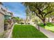 Well-maintained common area featuring lush green grass, mature trees, and walking paths at 10017 E Mountain View Road -- # 1045, Scottsdale, AZ 85258