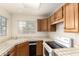 Practical kitchen space with tile counters, white appliances, and ample storage at 10017 E Mountain View Road -- # 1045, Scottsdale, AZ 85258
