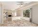 Bright living room with tiled flooring, neutral walls, and a cozy fireplace at 10017 E Mountain View Road -- # 1045, Scottsdale, AZ 85258