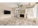 Inviting living area boasting a tiled fireplace, sliding glass doors and a ceiling fan at 10017 E Mountain View Road -- # 1045, Scottsdale, AZ 85258