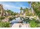Scenic pond with lush landscaping, mature trees, and tranquil water views for relaxation at 10017 E Mountain View Road -- # 1045, Scottsdale, AZ 85258