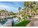 Community pond surrounded by lush landscaping, palm trees, and tranquil water views at 10017 E Mountain View Road -- # 1045, Scottsdale, AZ 85258