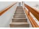 Modern staircase featuring wood treads, white risers, and beautiful wood railing at 10017 E Mountain View Road -- # 1045, Scottsdale, AZ 85258