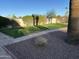 Manicured backyard featuring lush green grass, stone pathway, and well-maintained landscaping at 10249 N 58Th Pl, Paradise Valley, AZ 85253