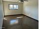 Spacious bedroom with wood floors, large window, and ceiling fan at 10249 N 58Th Pl, Paradise Valley, AZ 85253