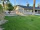 Exterior home view featuring a well-kept lawn, desert landscaping and block wall at 10249 N 58Th Pl, Paradise Valley, AZ 85253