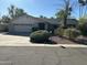 Charming single-story home with a well-maintained front yard and a two-car garage at 10249 N 58Th Pl, Paradise Valley, AZ 85253