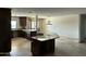 Spacious kitchen featuring dark wooden cabinetry, granite counter tops, and an island at 10249 N 58Th Pl, Paradise Valley, AZ 85253