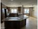 Well-lit kitchen featuring dark wooden cabinetry, granite counter tops, and an island at 10249 N 58Th Pl, Paradise Valley, AZ 85253