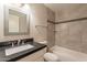 Updated bathroom featuring tile flooring, a modern vanity, and a tiled shower-over-tub at 1118 N Granite Reef Rd, Scottsdale, AZ 85257