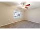 Comfortable bedroom featuring carpet flooring, a ceiling fan, and a window providing natural light at 1118 N Granite Reef Rd, Scottsdale, AZ 85257