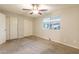 Carpeted bedroom featuring a ceiling fan, window, and double door closet at 1118 N Granite Reef Rd, Scottsdale, AZ 85257