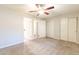 This airy bedroom features two closets and an open doorway with neutral walls and carpet at 1118 N Granite Reef Rd, Scottsdale, AZ 85257