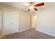 Cozy bedroom featuring carpet flooring, a ceiling fan, and spacious closet at 1118 N Granite Reef Rd, Scottsdale, AZ 85257