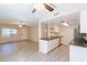 Modern kitchen with stainless steel appliances and a view of the living room, and wood look tile floors at 1118 N Granite Reef Rd, Scottsdale, AZ 85257