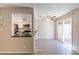 Bright living room with ceiling fan, wood look tile floors and access to kitchen with black counters at 1118 N Granite Reef Rd, Scottsdale, AZ 85257