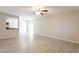 Bright living room with ceiling fan, wood look tile floors and sliding glass doors leading to a patio at 1118 N Granite Reef Rd, Scottsdale, AZ 85257