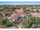 Expansive aerial view of a home with a red tile roof, lush landscaping, and a pool at 11319 E Elmhurst Dr, Chandler, AZ 85249