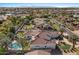 Aerial view of a red-roofed home with pool, manicured lawns, and desert landscaping at 11319 E Elmhurst Dr, Chandler, AZ 85249