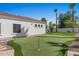 Backyard putting green with synthetic turf, mature trees, and easy access to main residence at 11319 E Elmhurst Dr, Chandler, AZ 85249