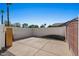 Open concrete patio area enclosed by a block wall and wood fence in a backyard at 11319 E Elmhurst Dr, Chandler, AZ 85249