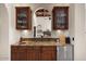 Convenient wet bar includes custom cabinets, granite counters, and a stainless steel mini fridge at 11319 E Elmhurst Dr, Chandler, AZ 85249