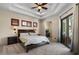 Spacious bedroom with tray ceiling, ceiling fan, and private backyard patio access at 11319 E Elmhurst Dr, Chandler, AZ 85249