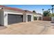Long driveway leading to a three-car garage and gated side entrance at 11319 E Elmhurst Dr, Chandler, AZ 85249