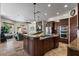 Open kitchen boasts custom cabinets, an oversized island, and modern stainless appliances at 11319 E Elmhurst Dr, Chandler, AZ 85249