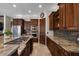 Well-equipped kitchen features ample granite counter space, stainless appliances, and dark wood cabinets at 11319 E Elmhurst Dr, Chandler, AZ 85249