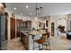 Spacious kitchen features granite counters, an island with seating, and tiled floors at 11319 E Elmhurst Dr, Chandler, AZ 85249