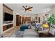 Open concept living room featuring stone accent wall, neutral paint, and ample natural light at 11319 E Elmhurst Dr, Chandler, AZ 85249