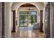 Elegant living room with dark wood columns, tile floors, fireplace, and sliding doors looking out to the pool at 11319 E Elmhurst Dr, Chandler, AZ 85249