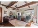Inviting living room with wood-beamed ceiling, ceiling fan, and comfortable seating at 11319 E Elmhurst Dr, Chandler, AZ 85249
